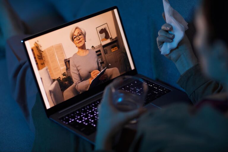 Image of a person in a teletherapy / attending online therapy from home for the blog What You Need to Know About Telehealth and Online Therapy | Soultenders