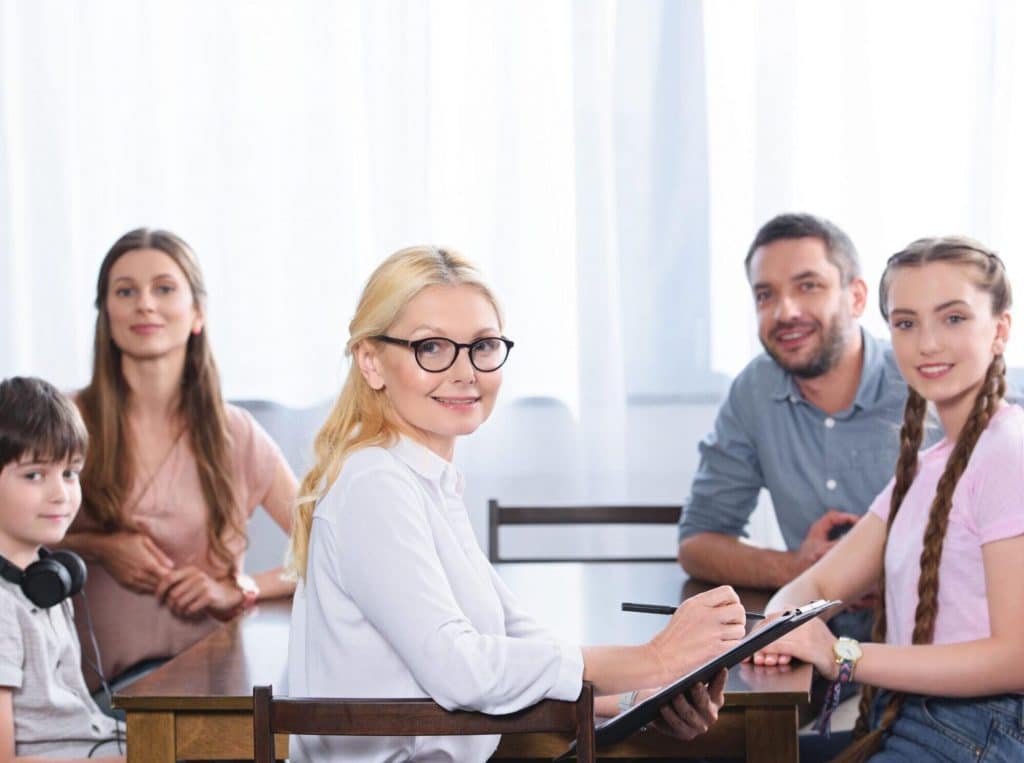An LMFT, which stands for licensed Marriage and Family Therapist, conducting a psychotherapy session with a family | Why do therapists have so many different credentials? by Soultenders